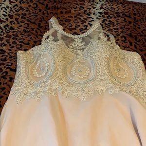 Cream colored dress with blue rhinestones.
